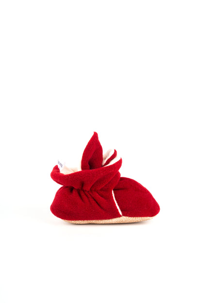 Comfortable and breathable baby booties in burgundy color with non-slip soles for safe adventures. Left single view.