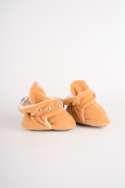 Comfortable and breathable baby booties in camel with non-slip soles for safe adventures. One step at a time.