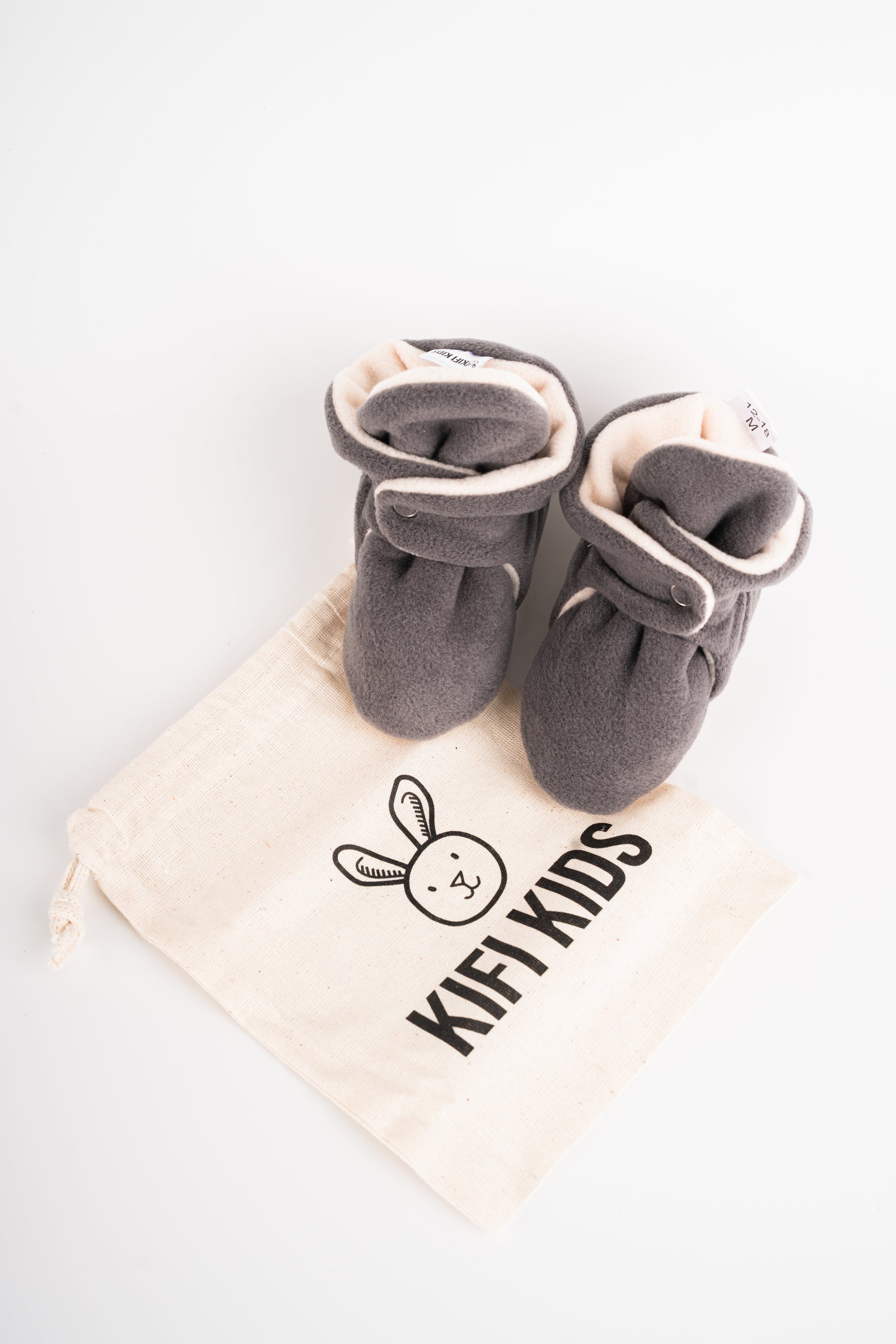 Comfortable and breathable baby booties in gray with non-slip soles for safe adventures. Above view.