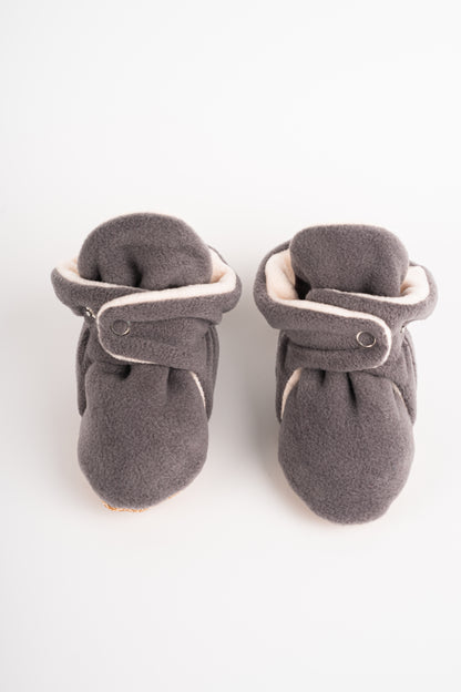 Comfortable and breathable baby booties in gray with non-slip soles for safe adventures. Front view.