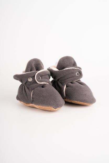 Comfortable and breathable baby booties in gray with non-slip soles for safe adventures. side view.