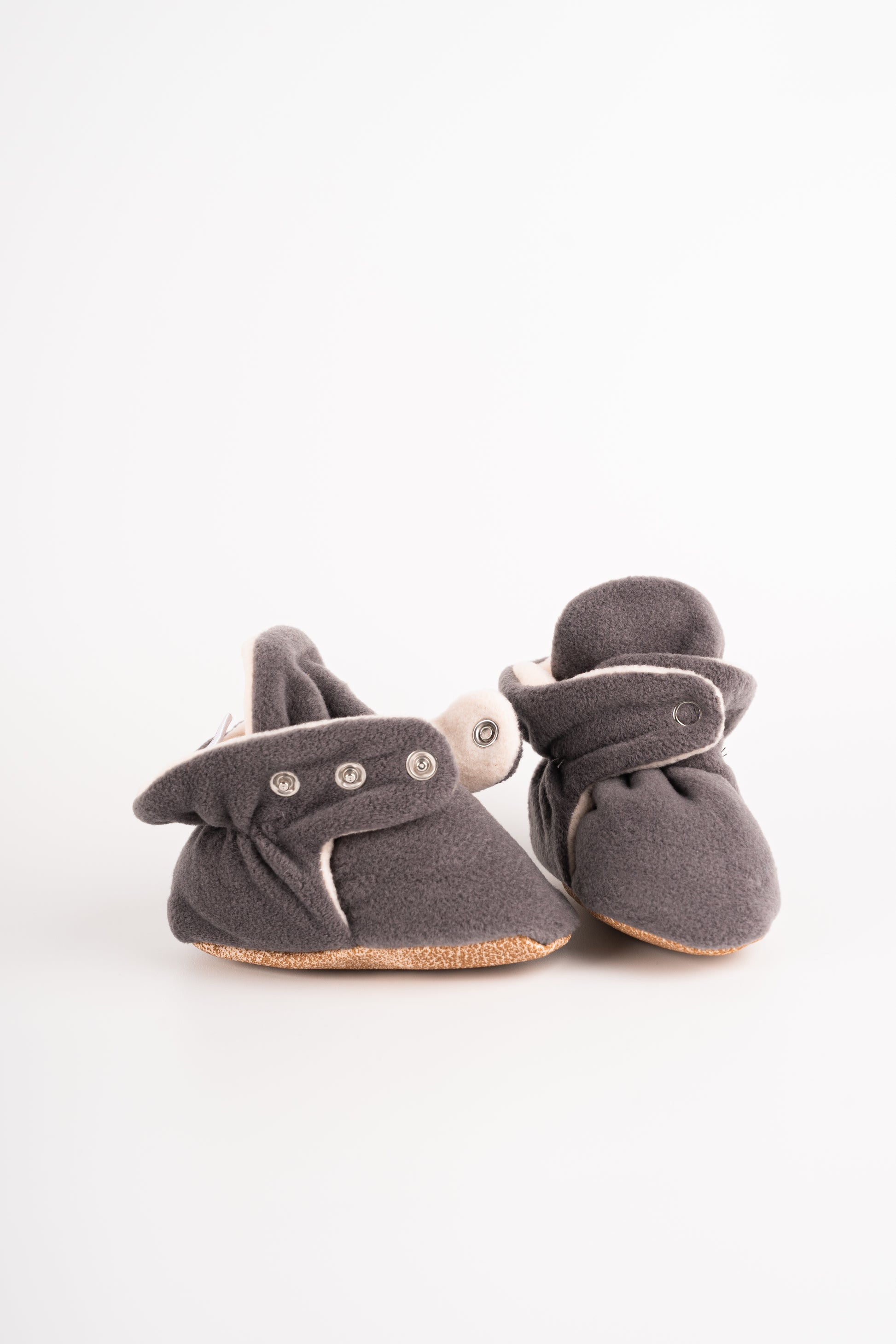 Comfortable and breathable baby booties in gray with non-slip soles for safe adventures.